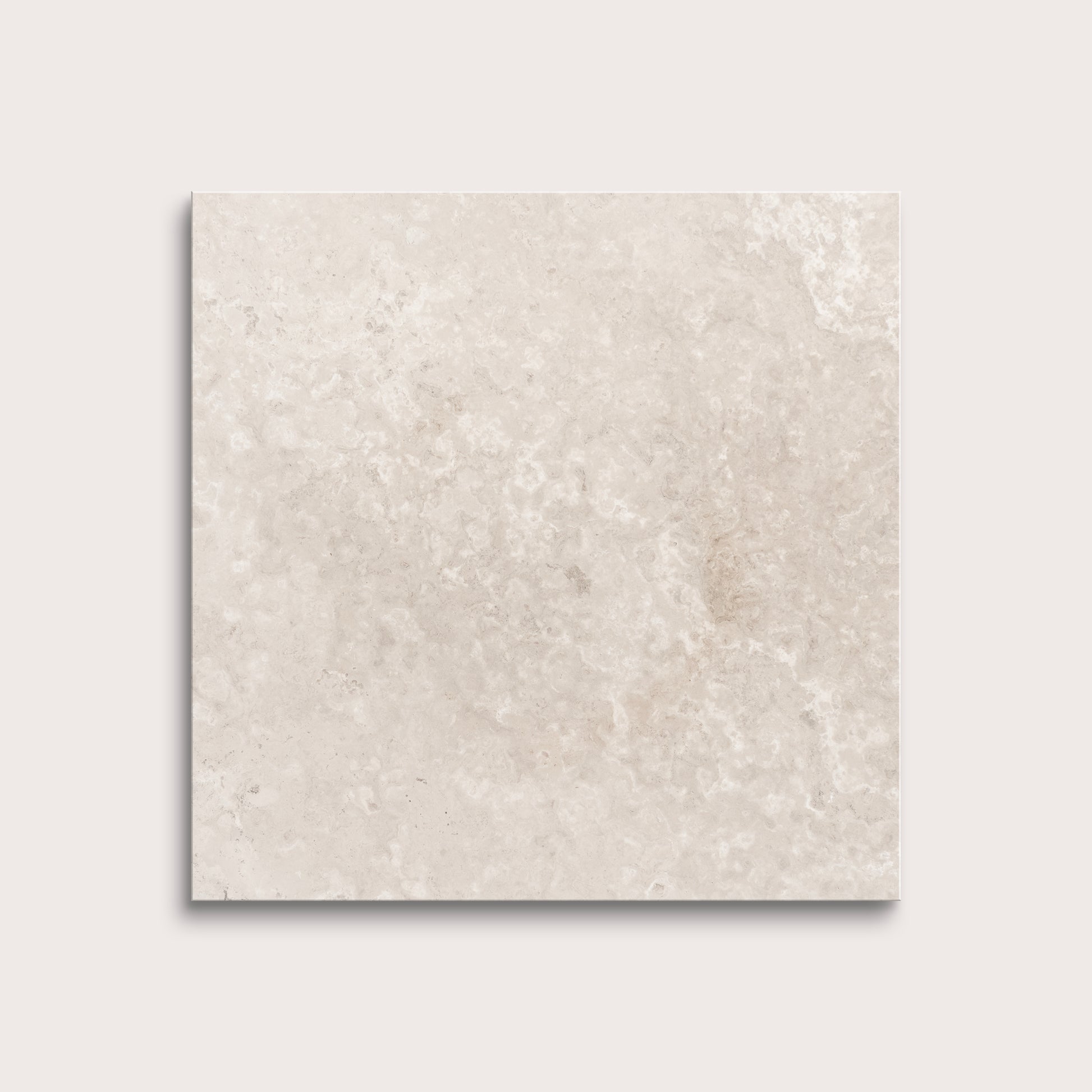 Beige limestone tile on a light gray background