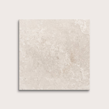 Beige limestone tile on a light gray background