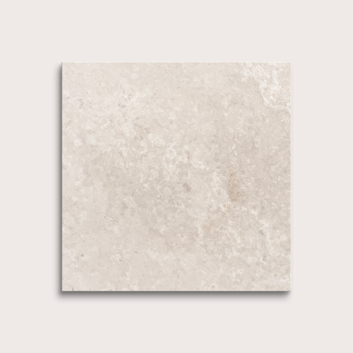 Beige limestone tile on a light gray background