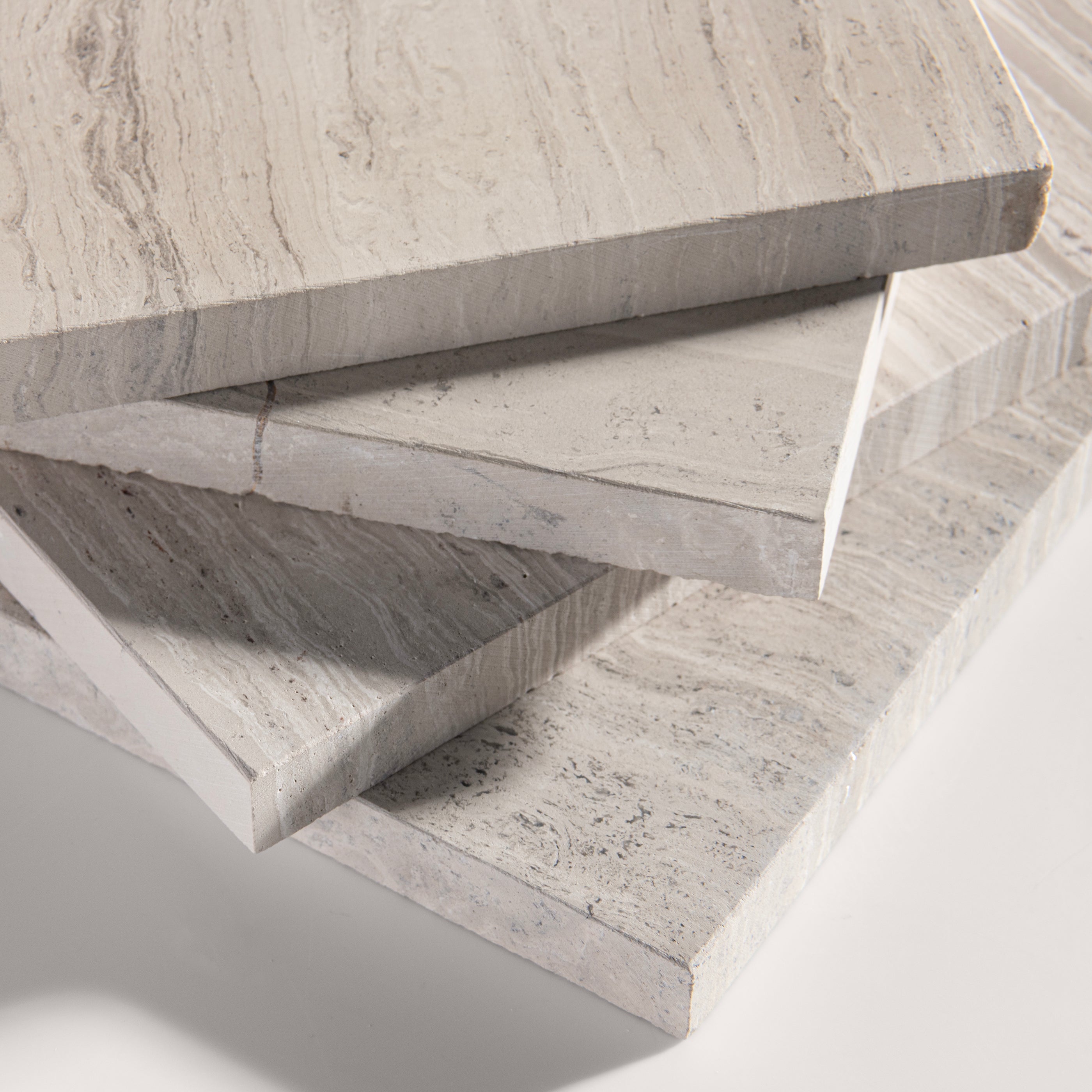 close up angle of Beige limestone tile on a light gray background