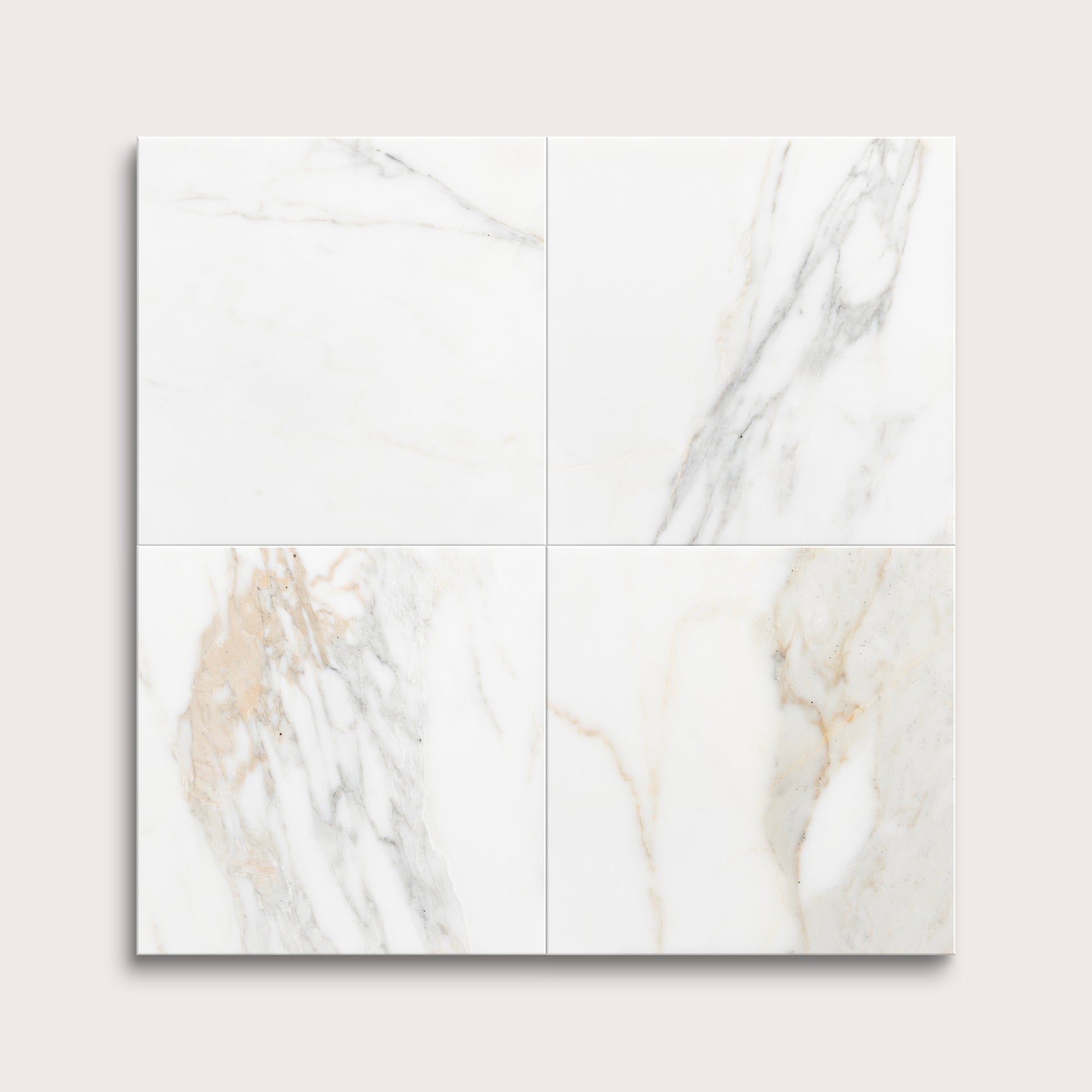 calacatta gold Marble tiles arranged in a grid on a light gray background
