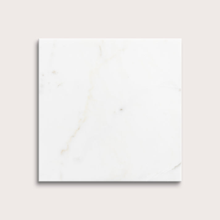 calacatta gold Marble tiles on a light gray background
