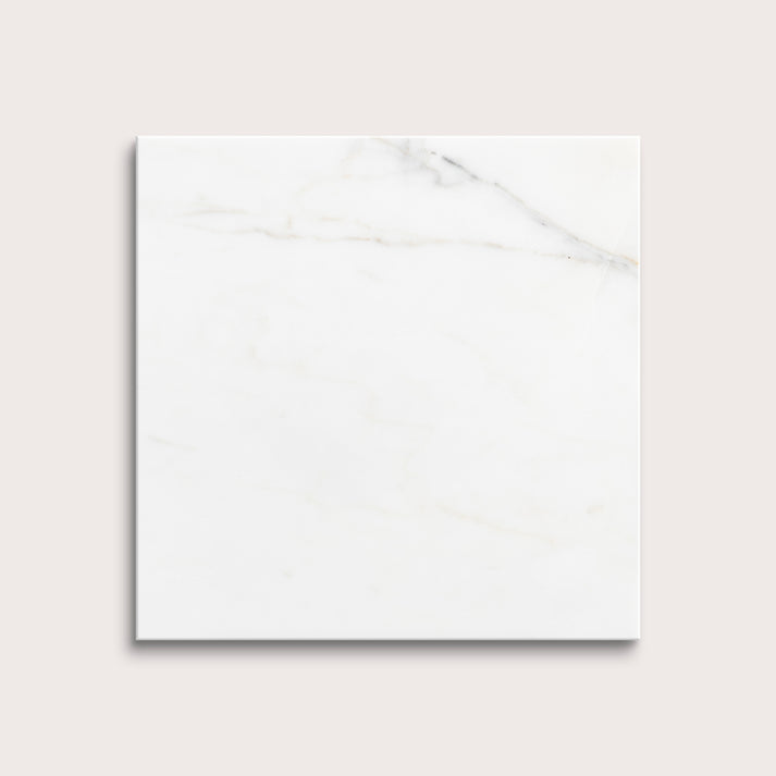 calacatta gold Marble tiles on a light gray background