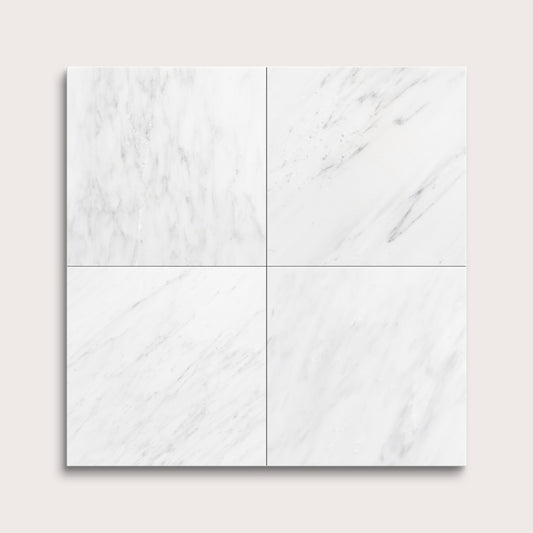 White casablanca carrara marble tiles arranged in a grid pattern on a light gray background