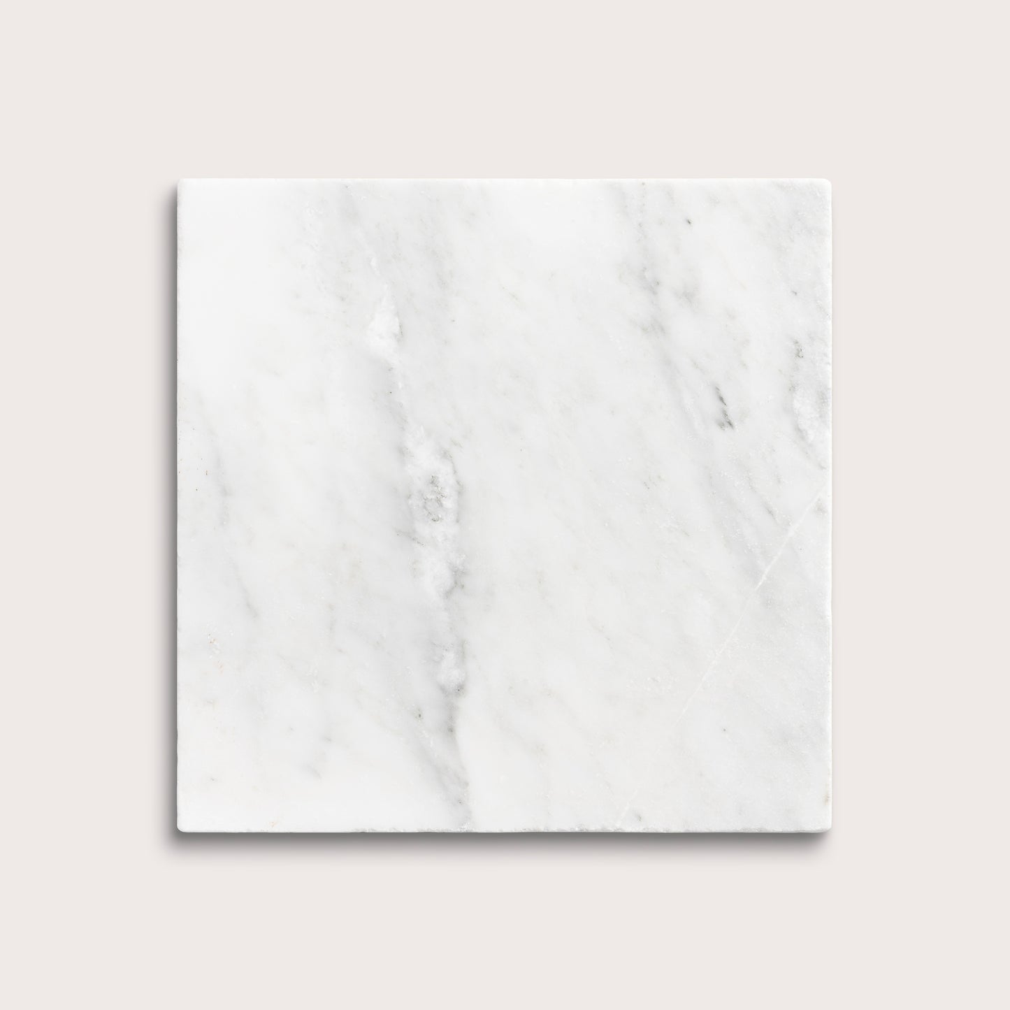 White casablanca carrara marble tiles on a light gray background