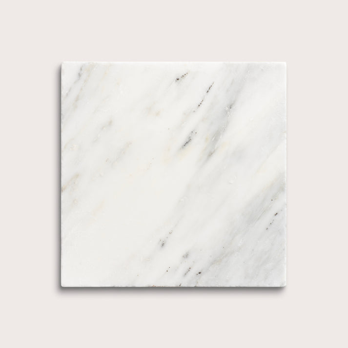 White casablanca carrara marble tiles on a light gray background