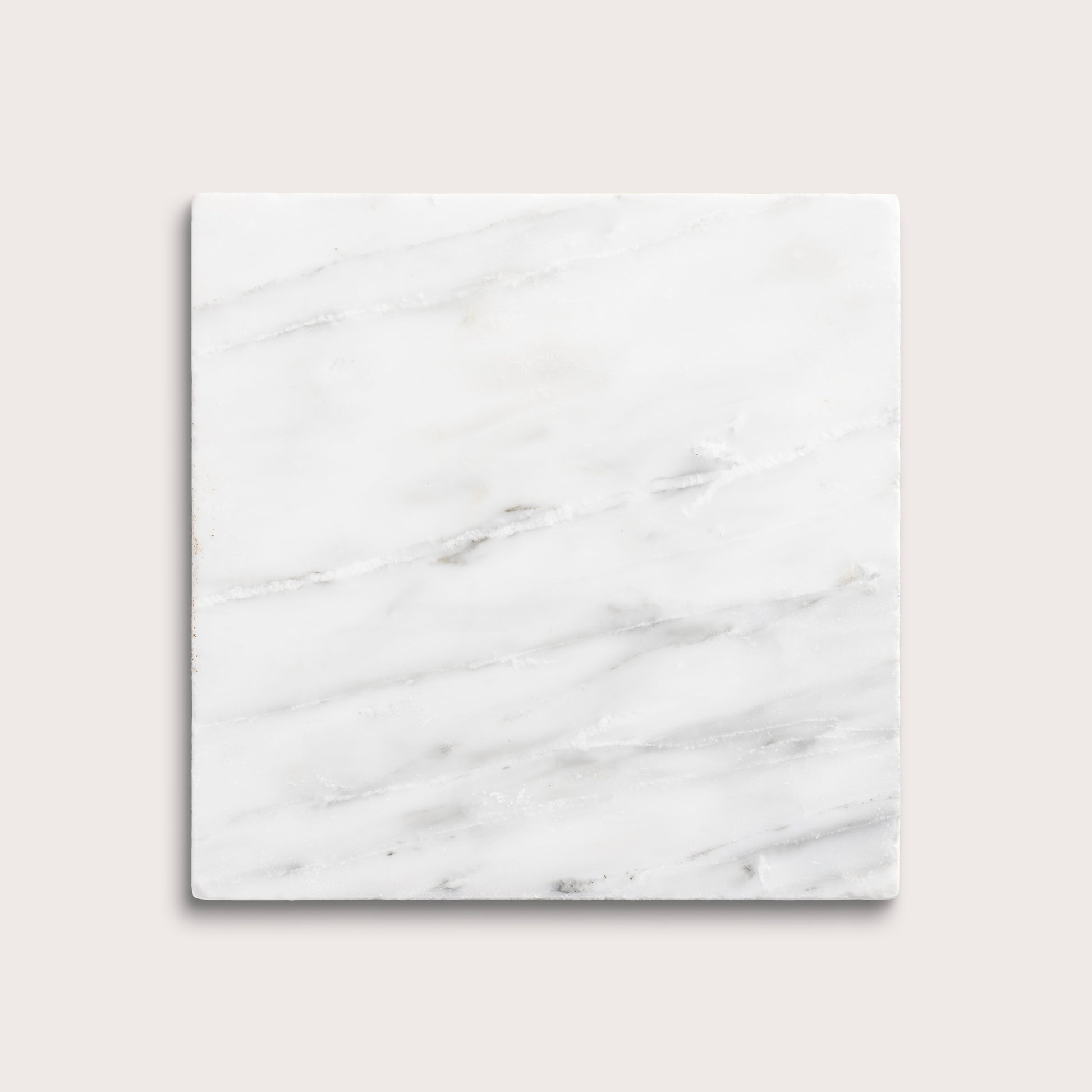 White casablanca carrara marble tiles on a light gray background