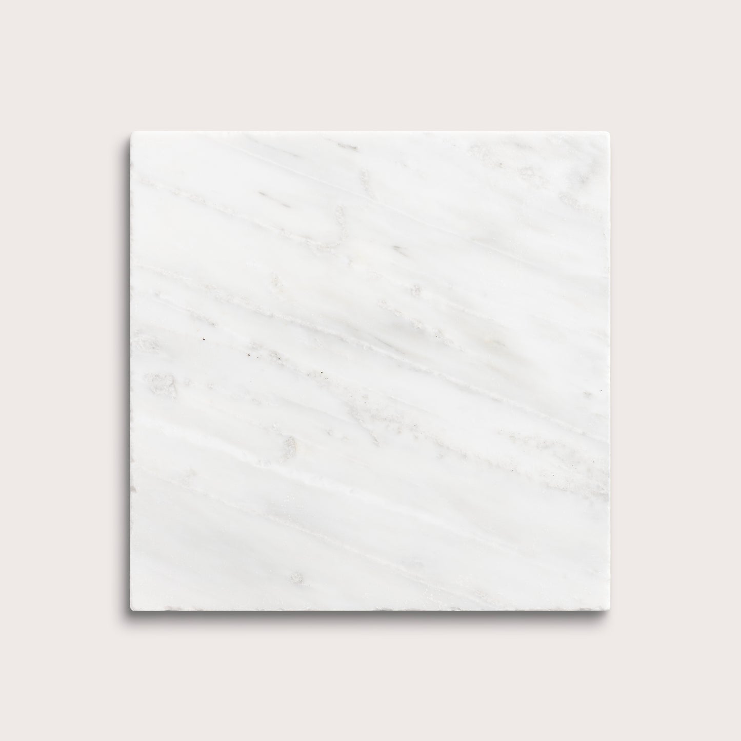 White casablanca carrara marble tiles on a light gray background