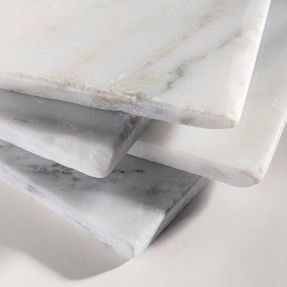 close up angle of White casablanca carrara marble tiles on a light gray background