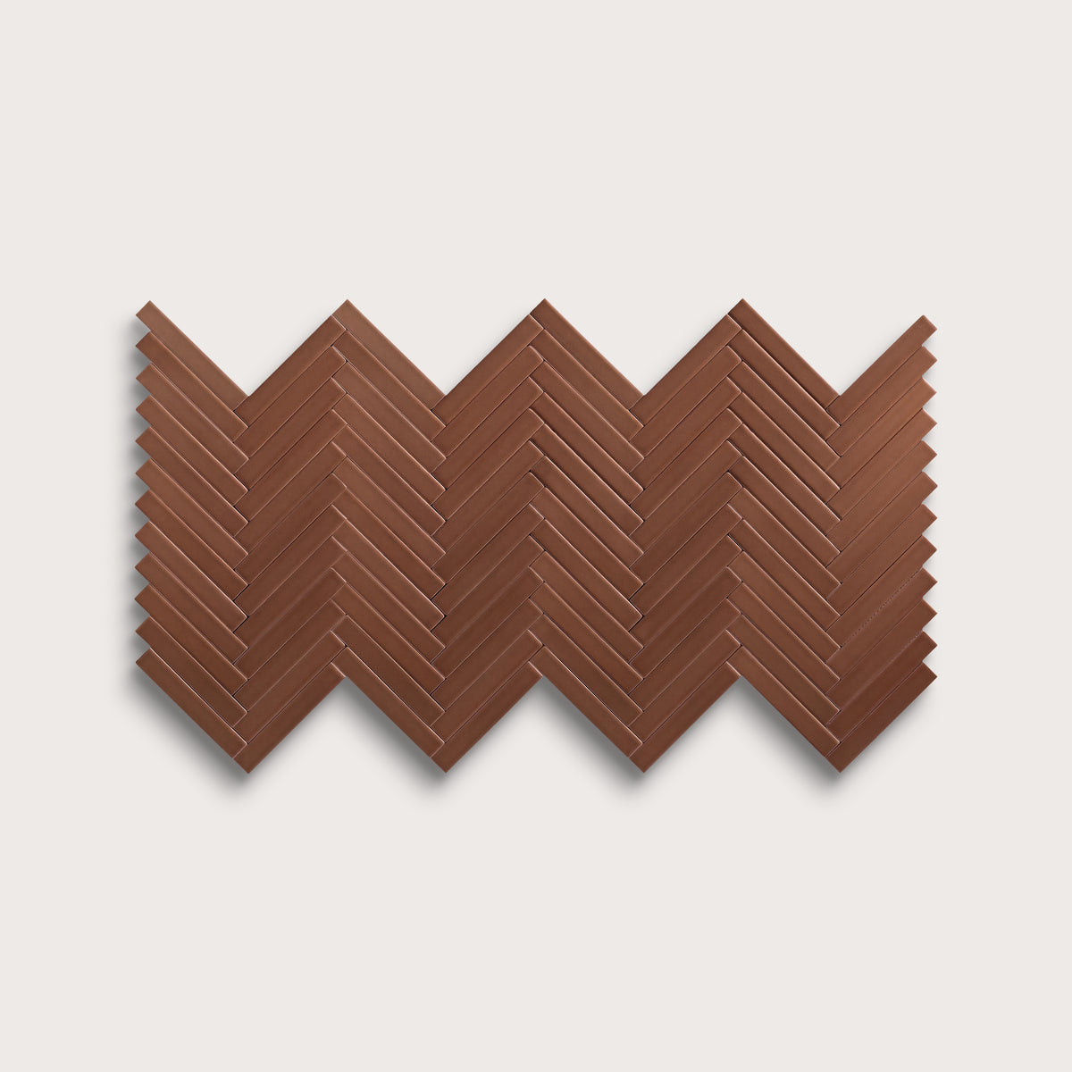 Amber ceramic tile, 1 by 6 inch herringbone mosaic, matte finish
