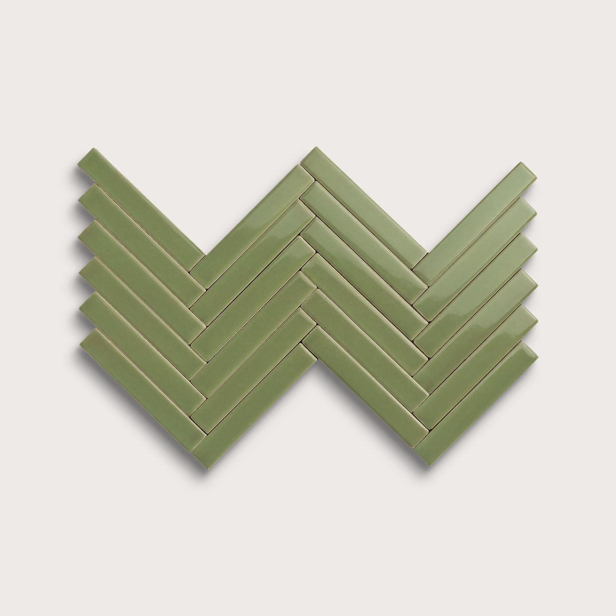 Cactus Green ceramic tile, 1 by 6 inch herringbone mosaic, gloss finish