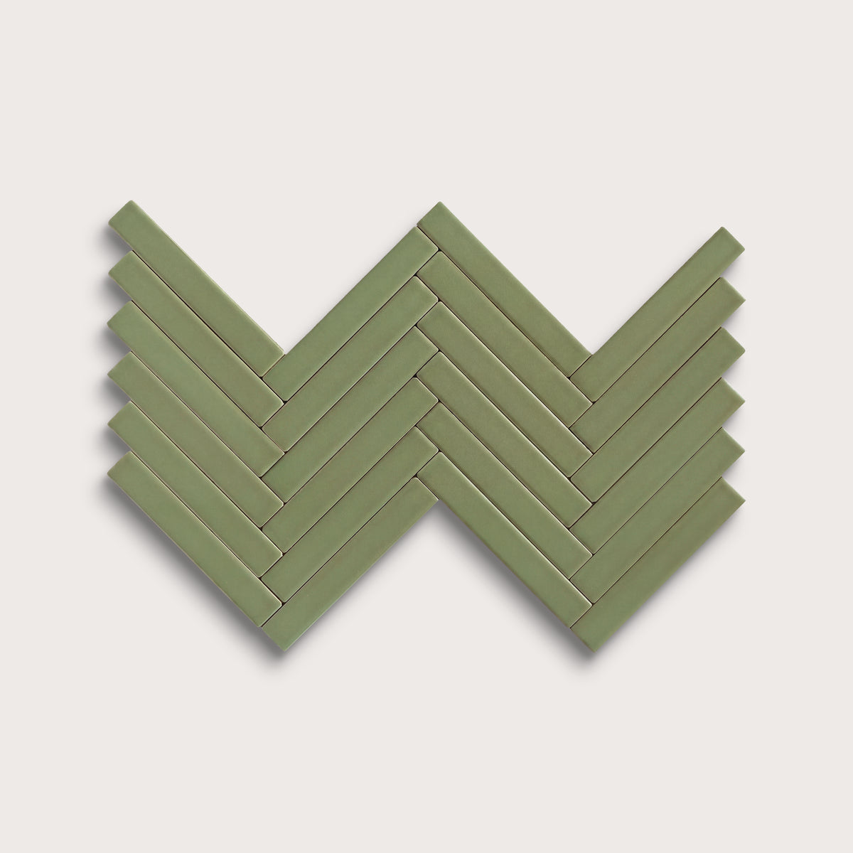 Cactus Green ceramic tile, 1 by 6 inch herringbone mosaic, matte finish