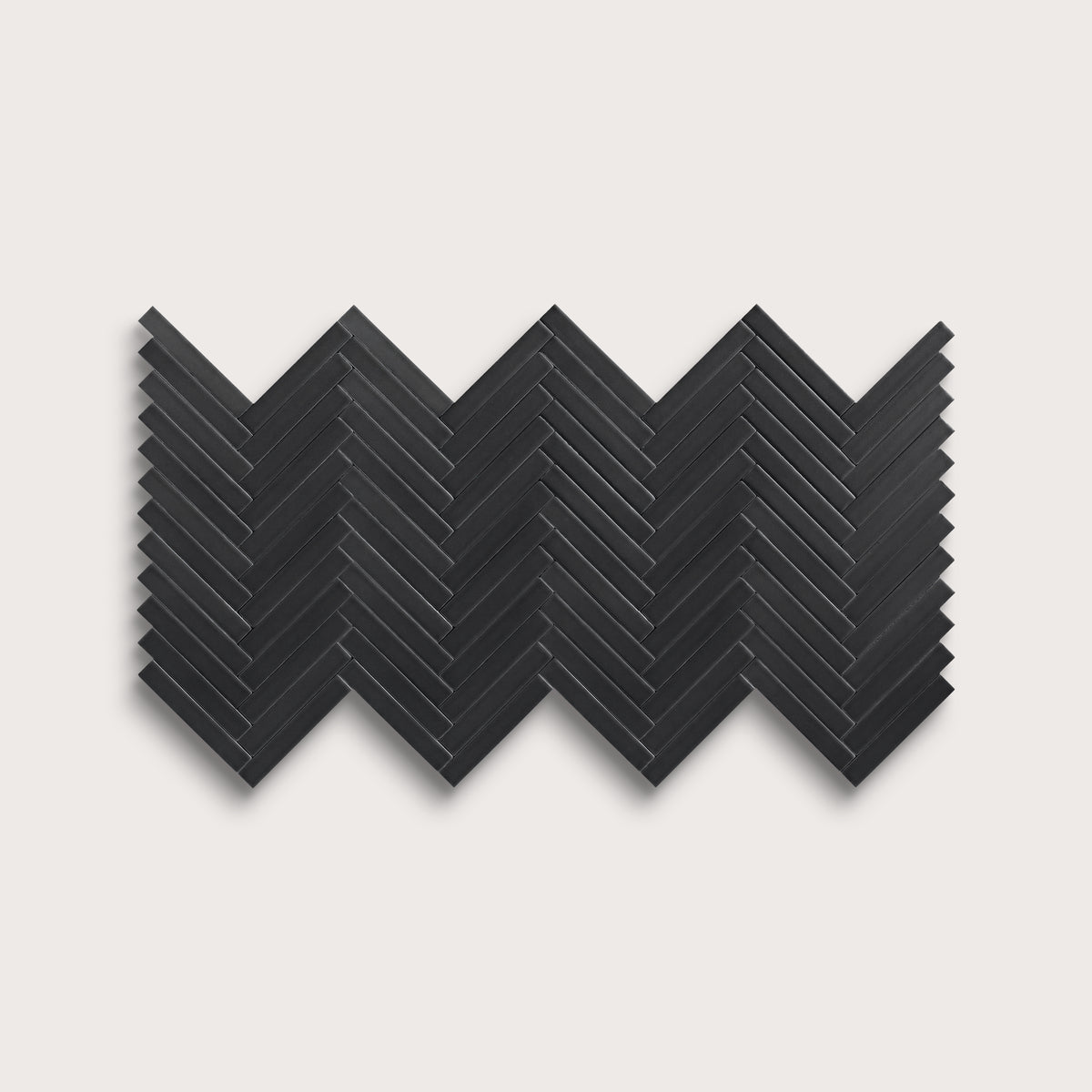 Deep Black ceramic tile, 1 by 6 inch herringbone mosaic, matte finish