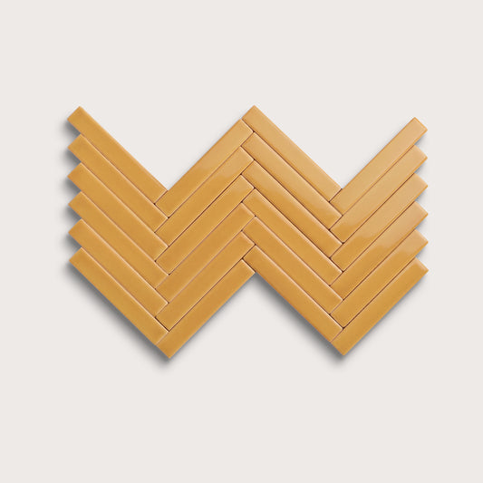 Gambol Gold ceramic tile, 1 by 6 inch herringbone mosaic, gloss finish