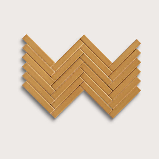 Gambol Gold ceramic tile, 1 by 6 inch herringbone mosaic, matte finish