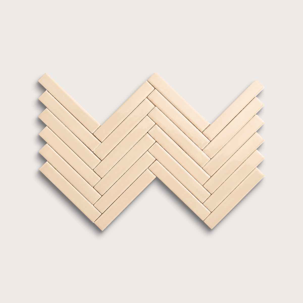 Latte ceramic tile, 1 by 6 inch herringbone mosaic, gloss finish