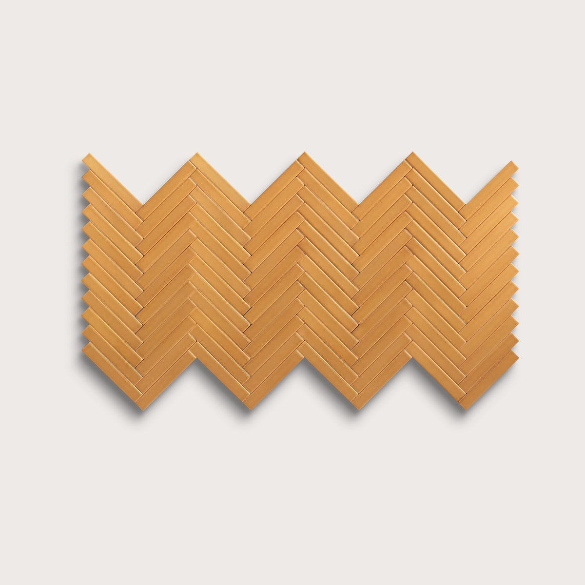 Marigold ceramic tile, 1 by 6 inch herringbone mosaic, matte finish