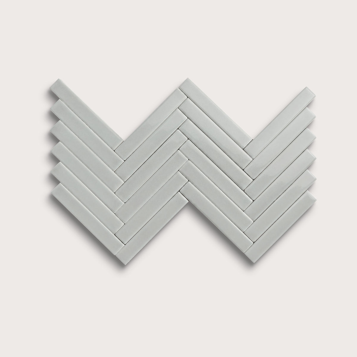 Misty ceramic tile, 1 by 6 inch herringbone mosaic, gloss finish
