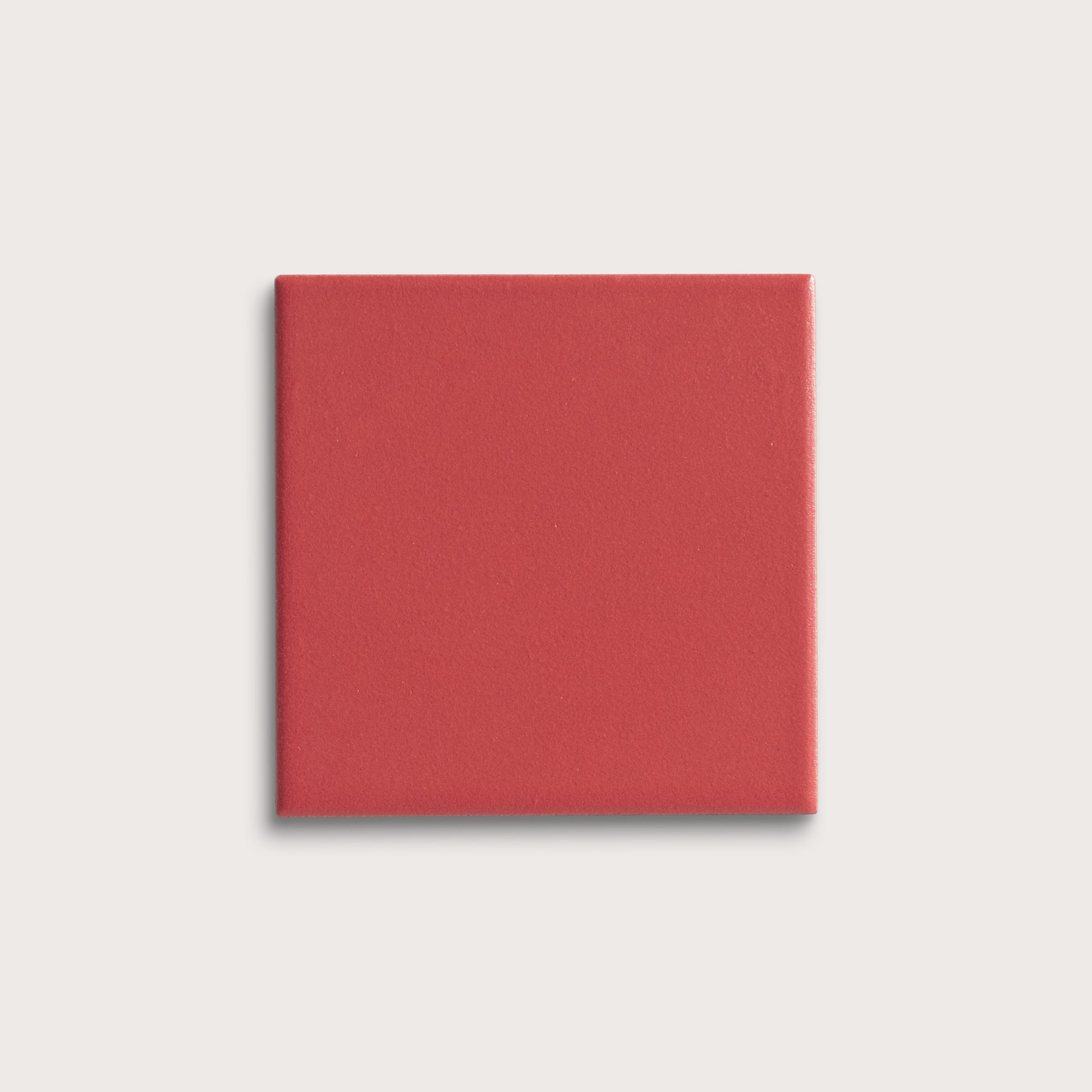 Red square tile on a light gray background