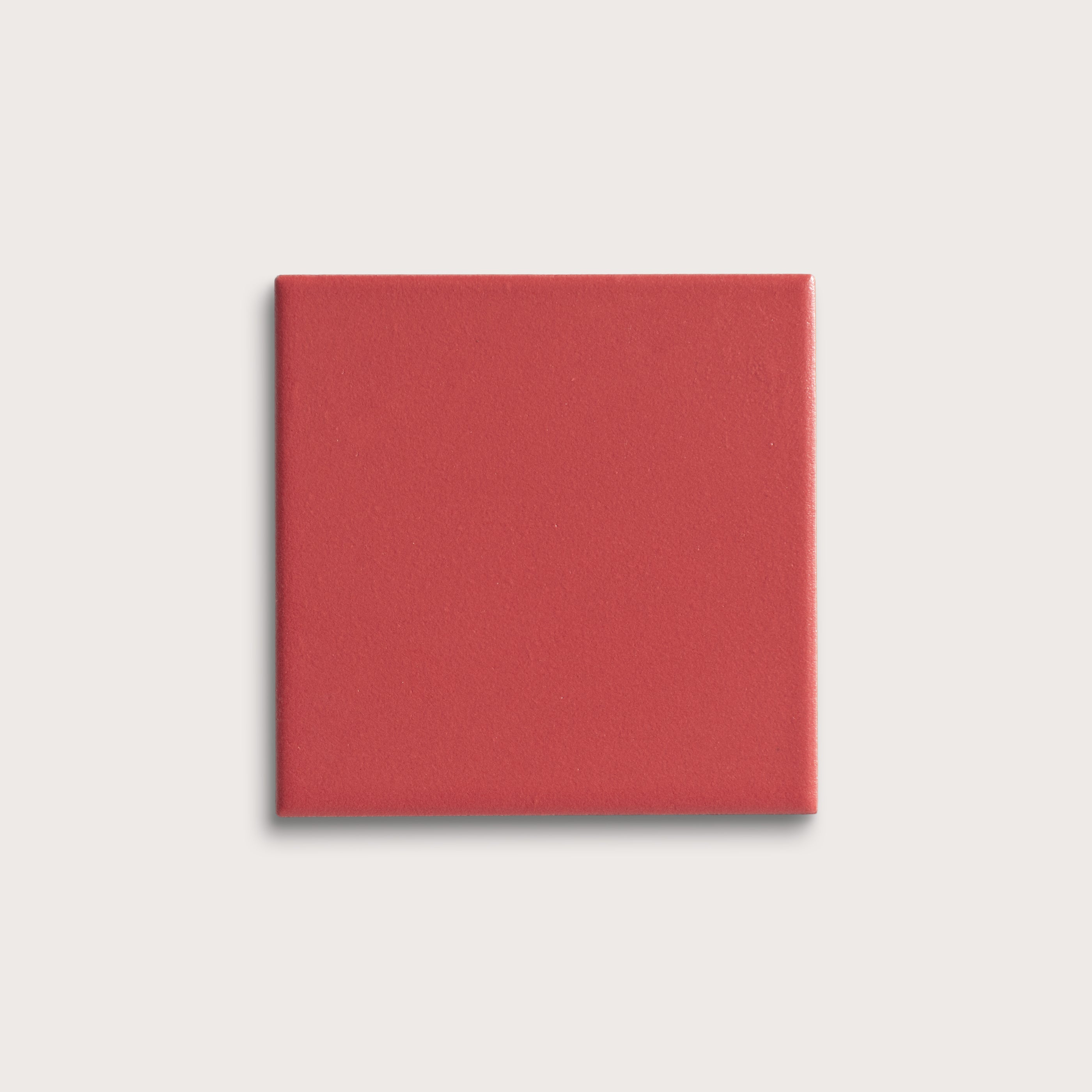 Red square tile on a light gray background