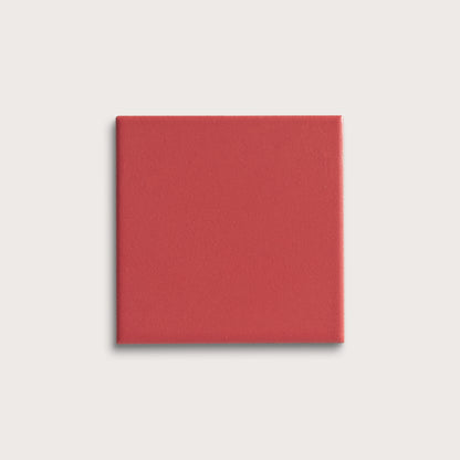 Red square tile on a light gray background
