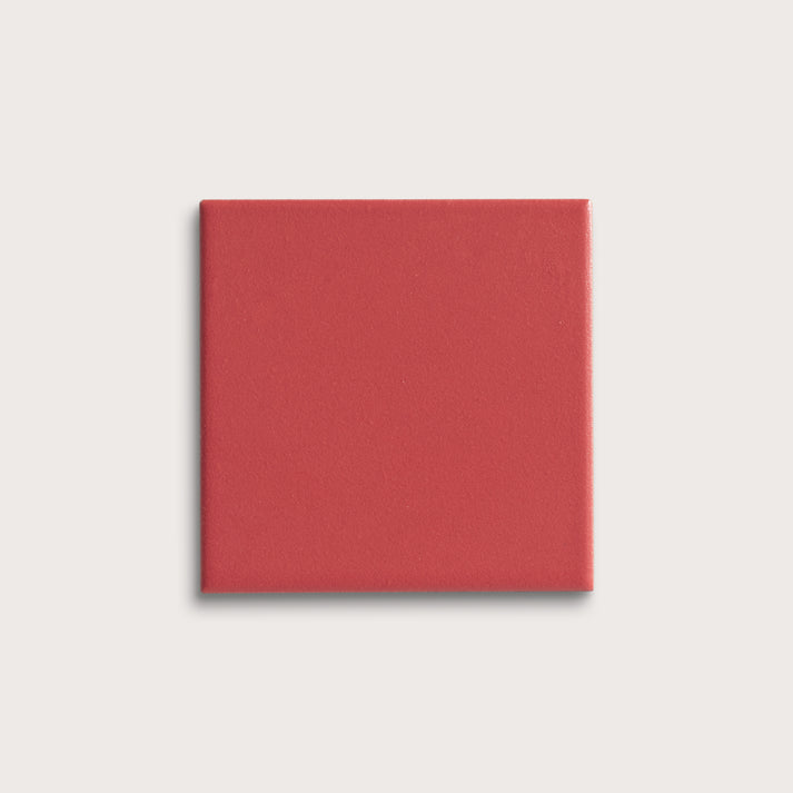 Red square tile on a light gray background