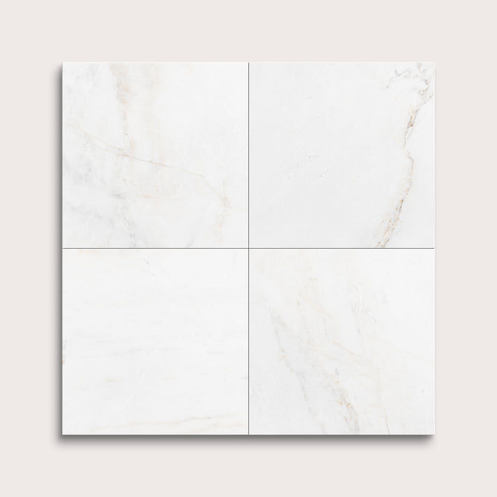 casablanca gold White marble tiles arranged in a grid pattern on a light gray background