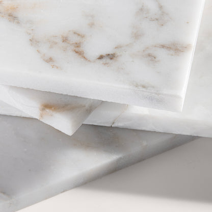 close up angle of casablanca gold White marble tiles on a light gray background