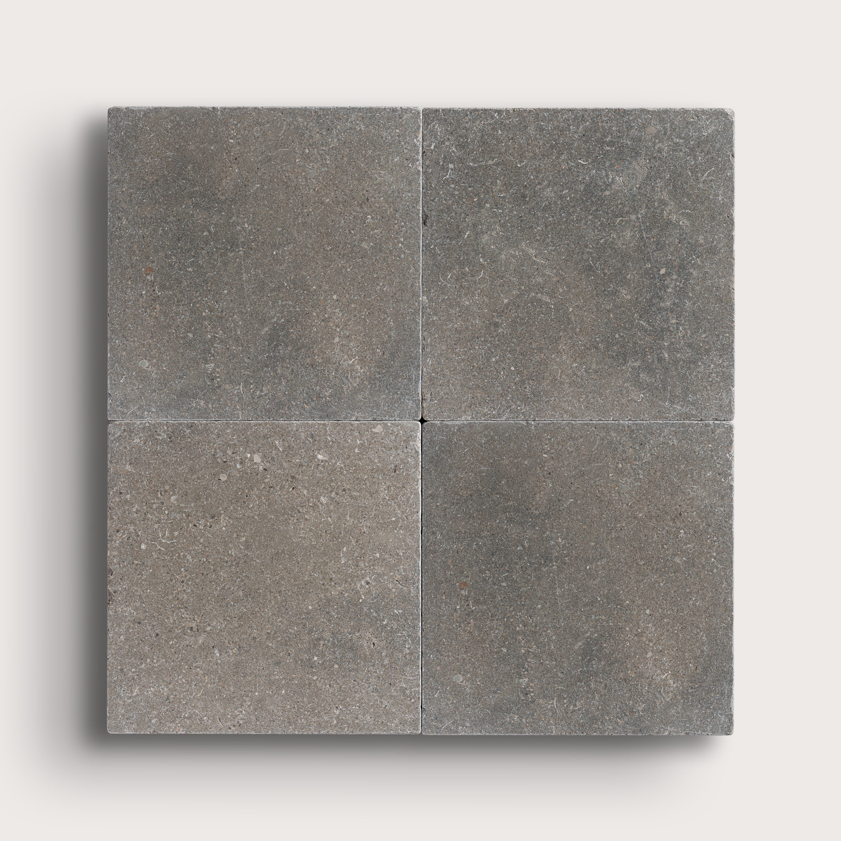 grey square limestone tile in grid pattern on light grey background