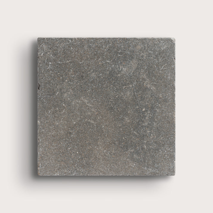 grey square limestone tile on light grey background