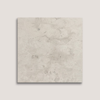 Square tile with a light gray, textured surface on a white background