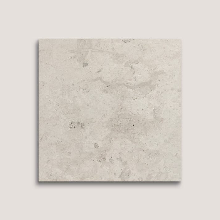 Square tile with a light gray, textured surface on a white background