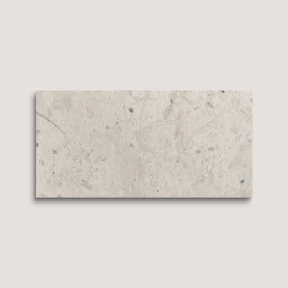 Rectangular limestone tile with a beige and gray marbled pattern on a light gray background