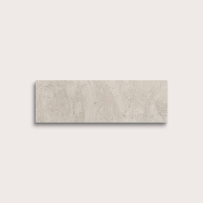 Rectangular beige tile on a light gray background