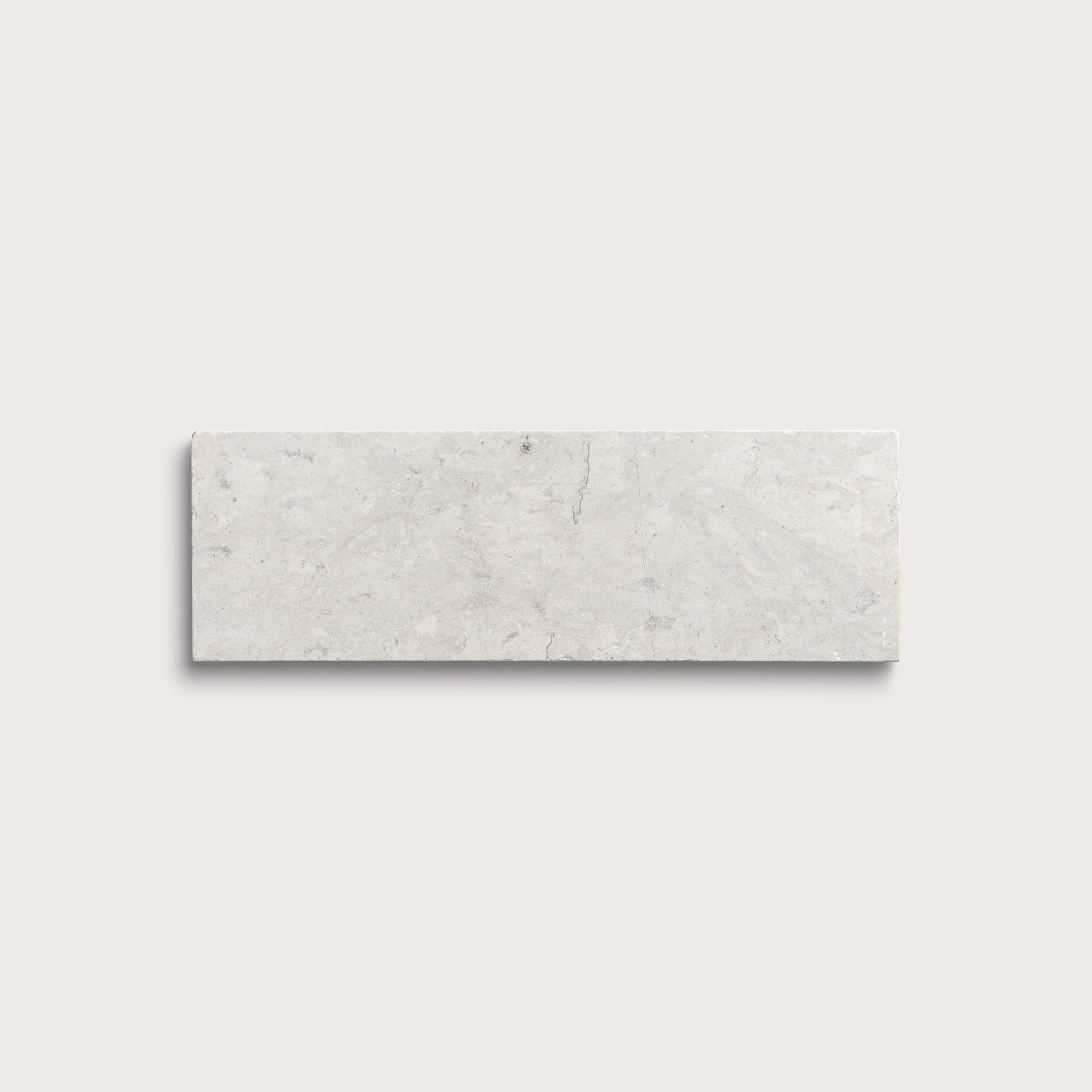rectangular tile with a grey limestone pattern on a white background
