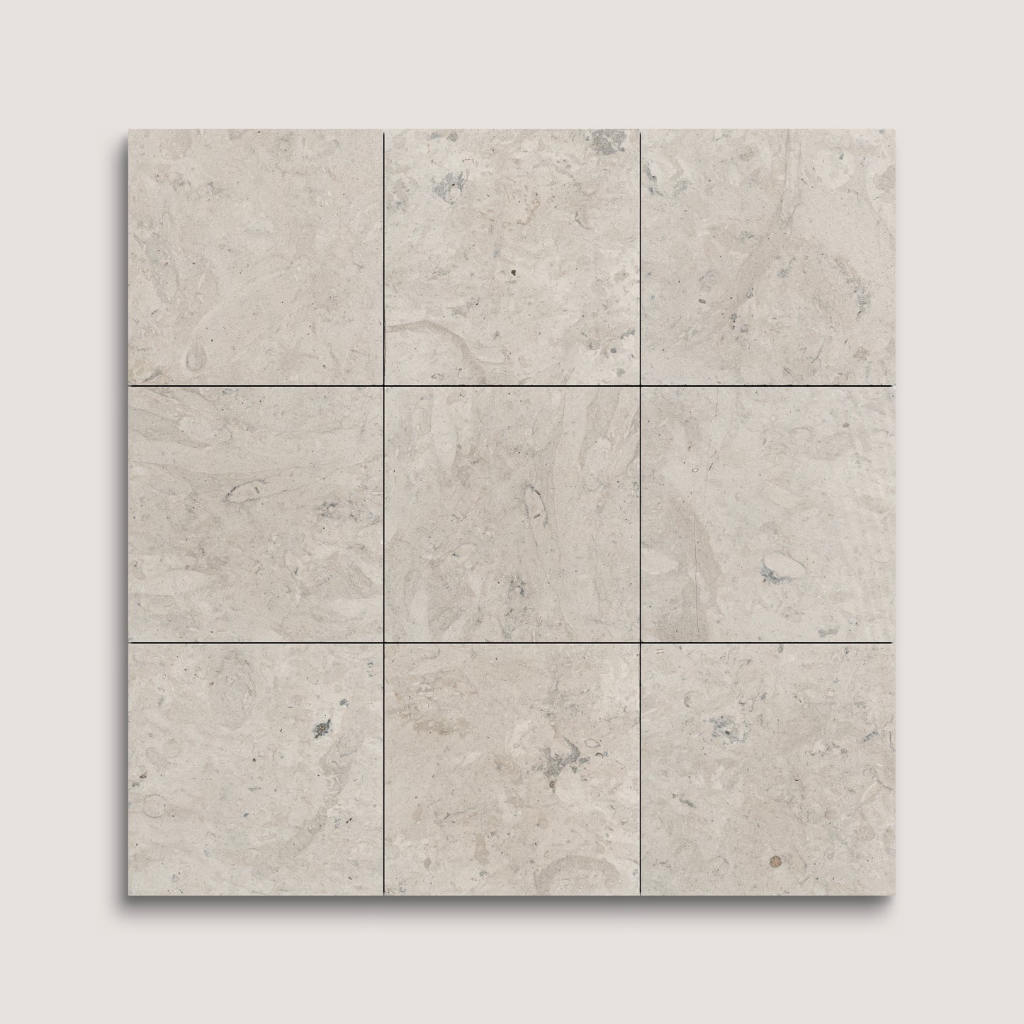 Nine square tiles with a beige and gray limestone pattern on a light gray background