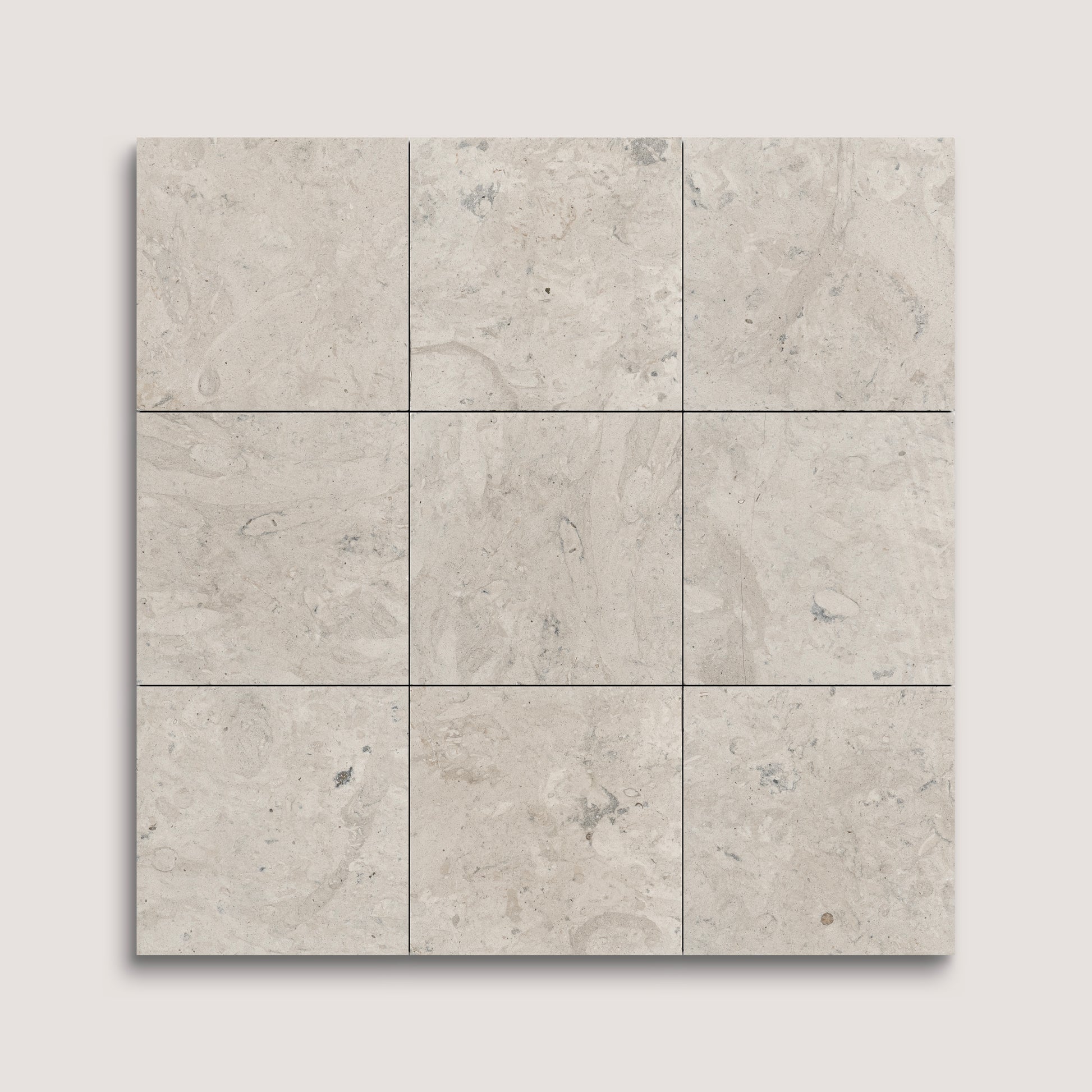 Nine square tiles with a beige and gray limestone pattern on a light gray background