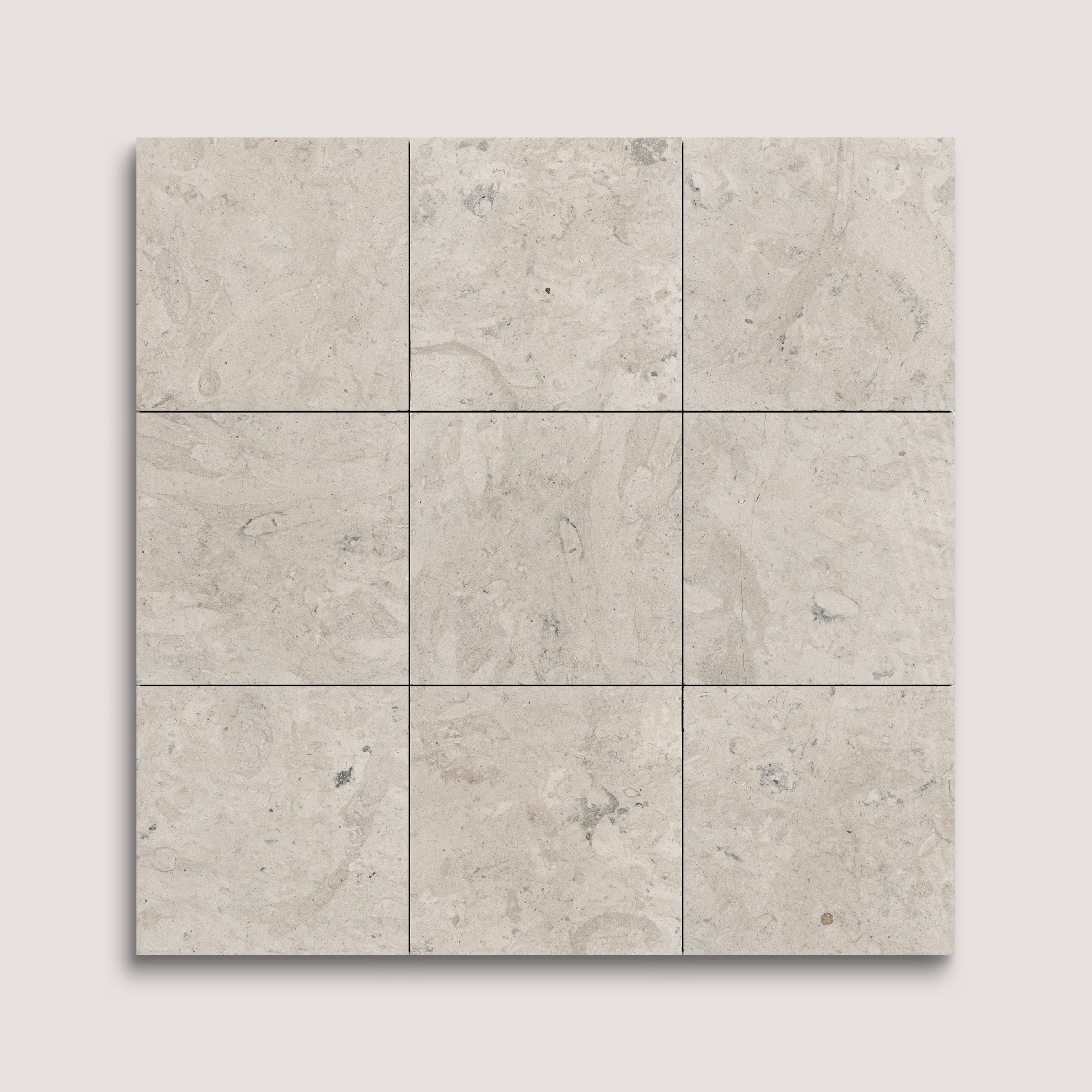Nine square tiles with a beige and gray limestone pattern on a light gray background