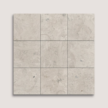 Nine square tiles with a beige and gray limestone pattern on a light gray background