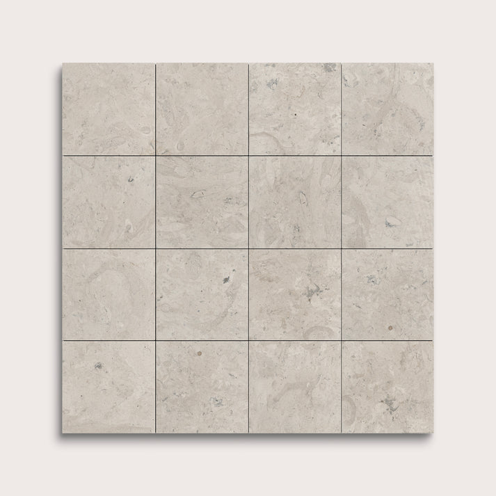Square tiles with a light gray pattern on a white background