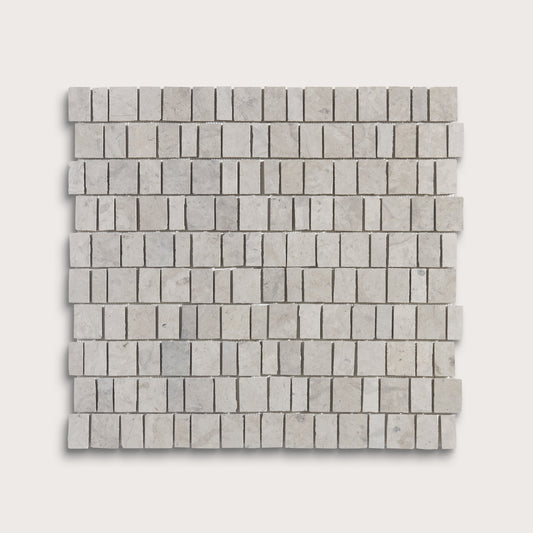 A square sample of light gray marble mosaic tiles arranged in a staggered brick pattern, shown against a solid off-white background.