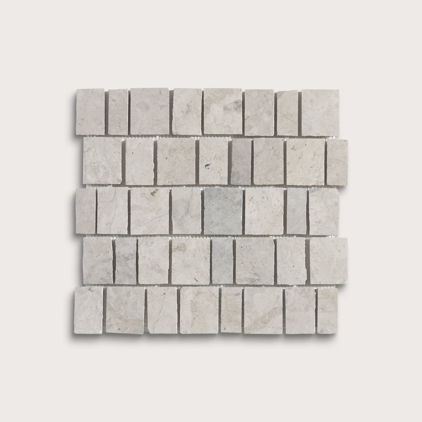 A square mosaic tile sample made of light gray rectangular travertine or marble chips arranged in a staggered brick pattern, shown on a plain light gray background.