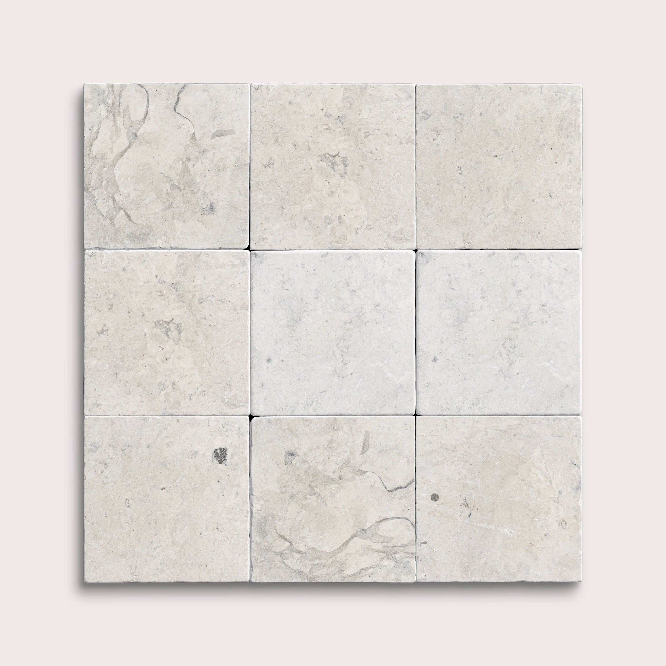 nine square tiles with a grey limestone pattern on a white background