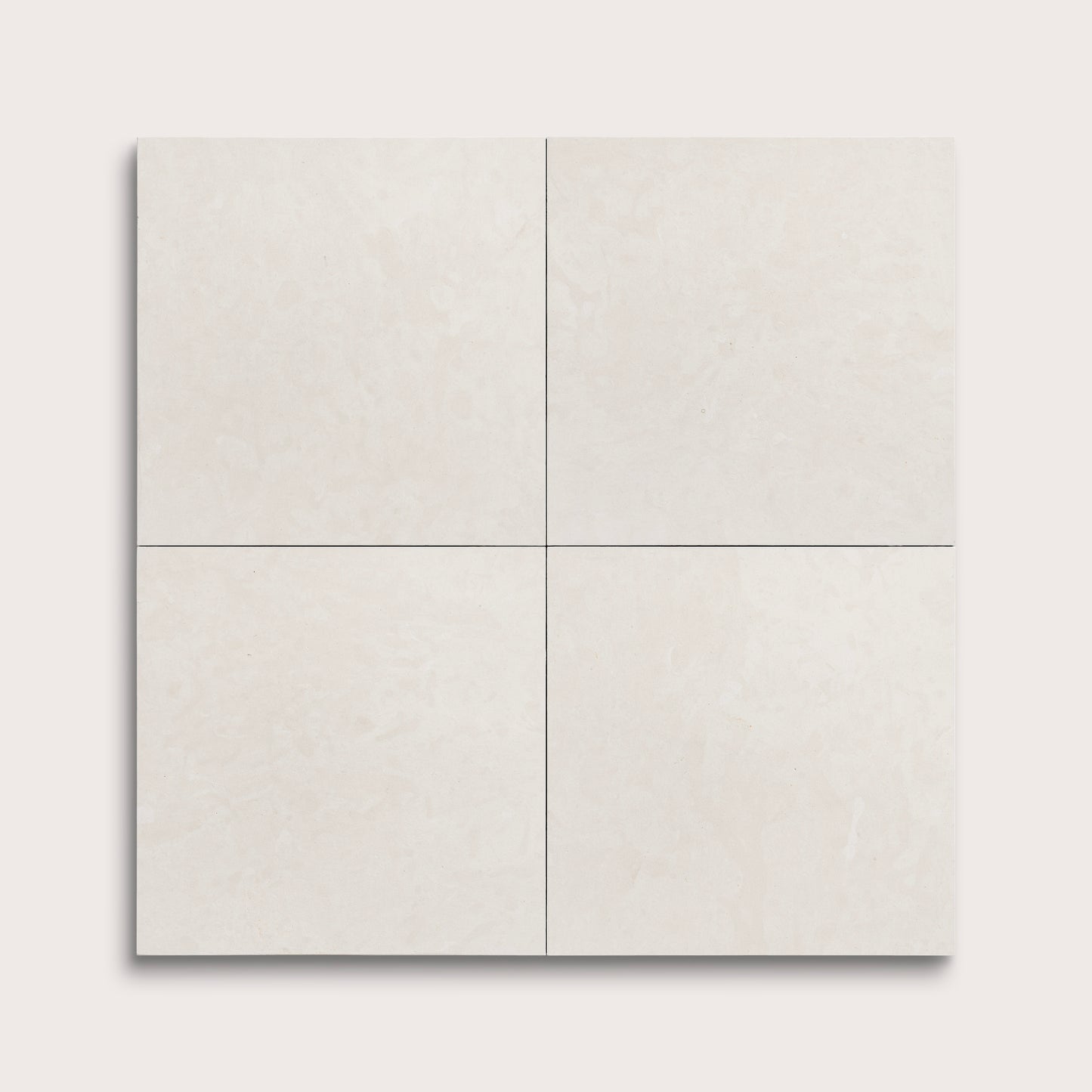 four square tiles with a white limestone pattern on a white background