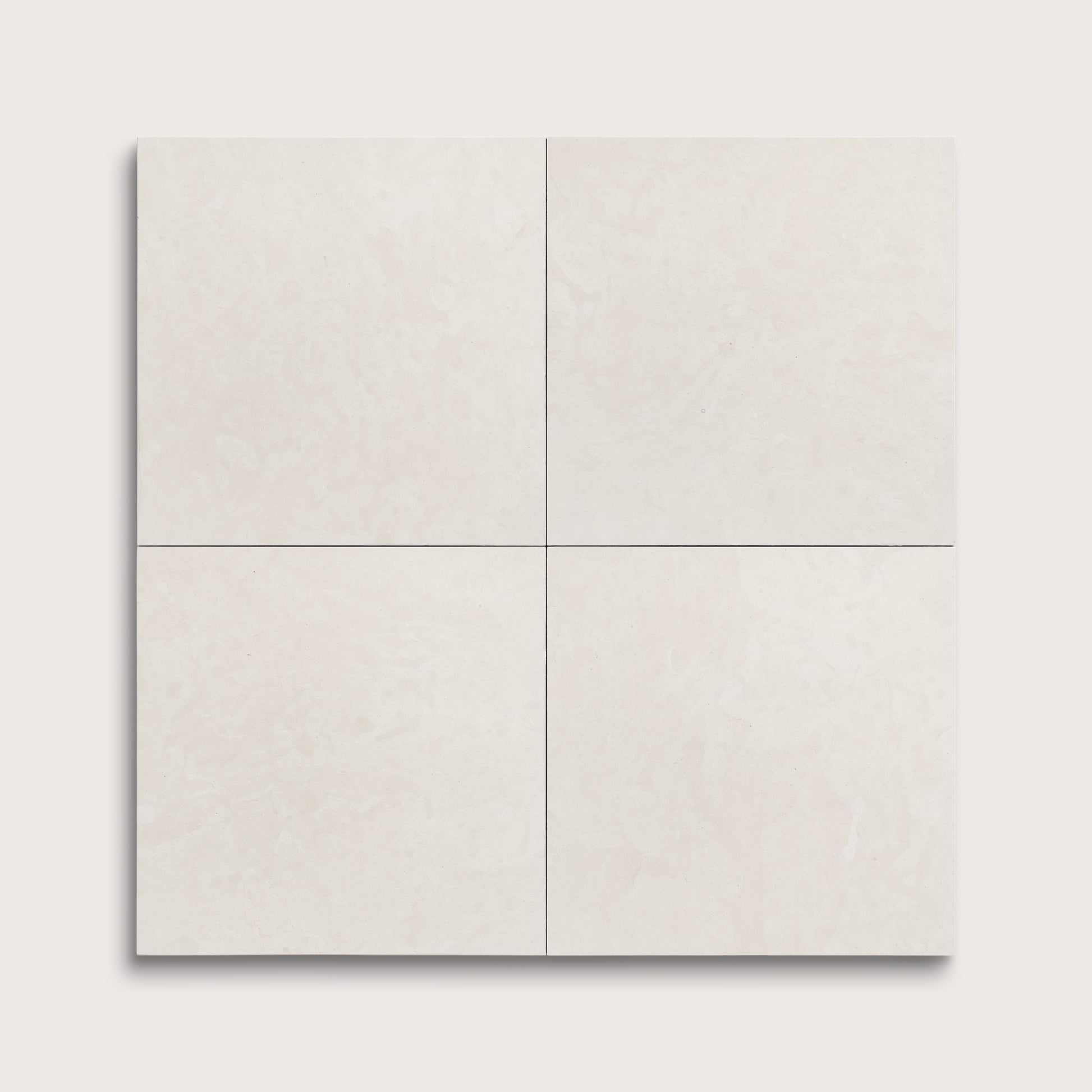 four square tiles with a white limestone pattern on a white background
