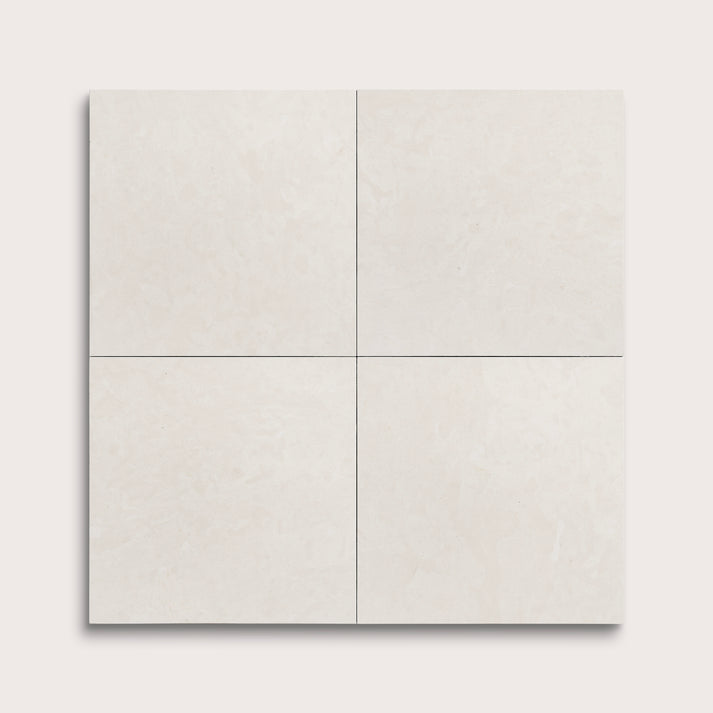 four square tiles with a white limestone pattern on a white background