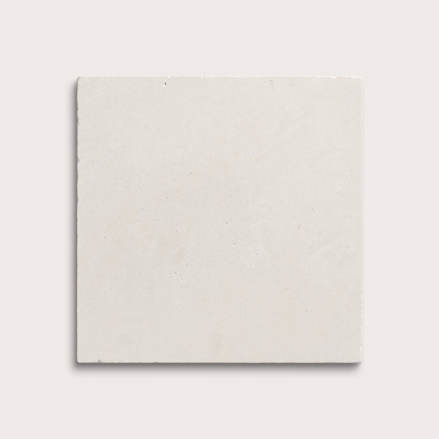 square tile with a white limestone pattern on a white background