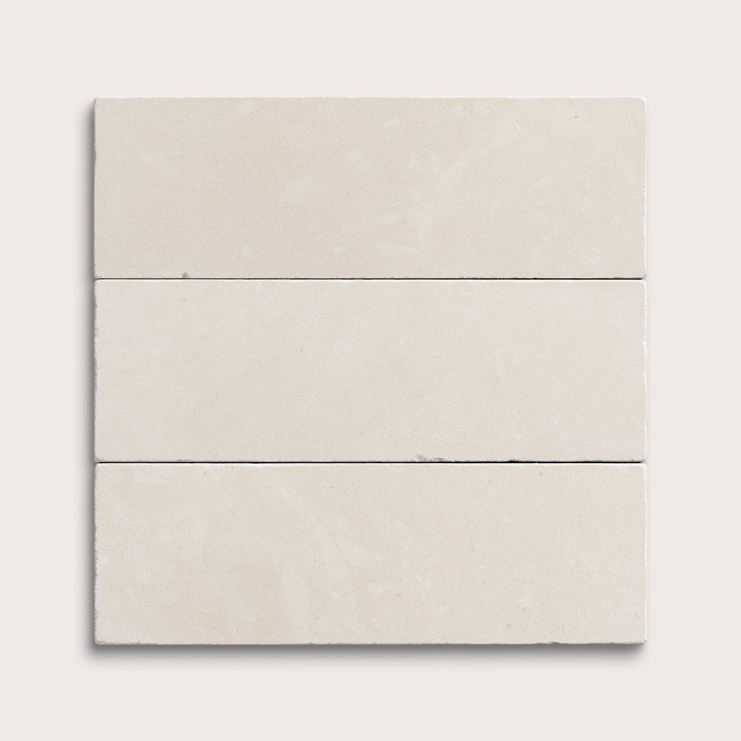 three rectangle tiles with a white limestone pattern on a white background
