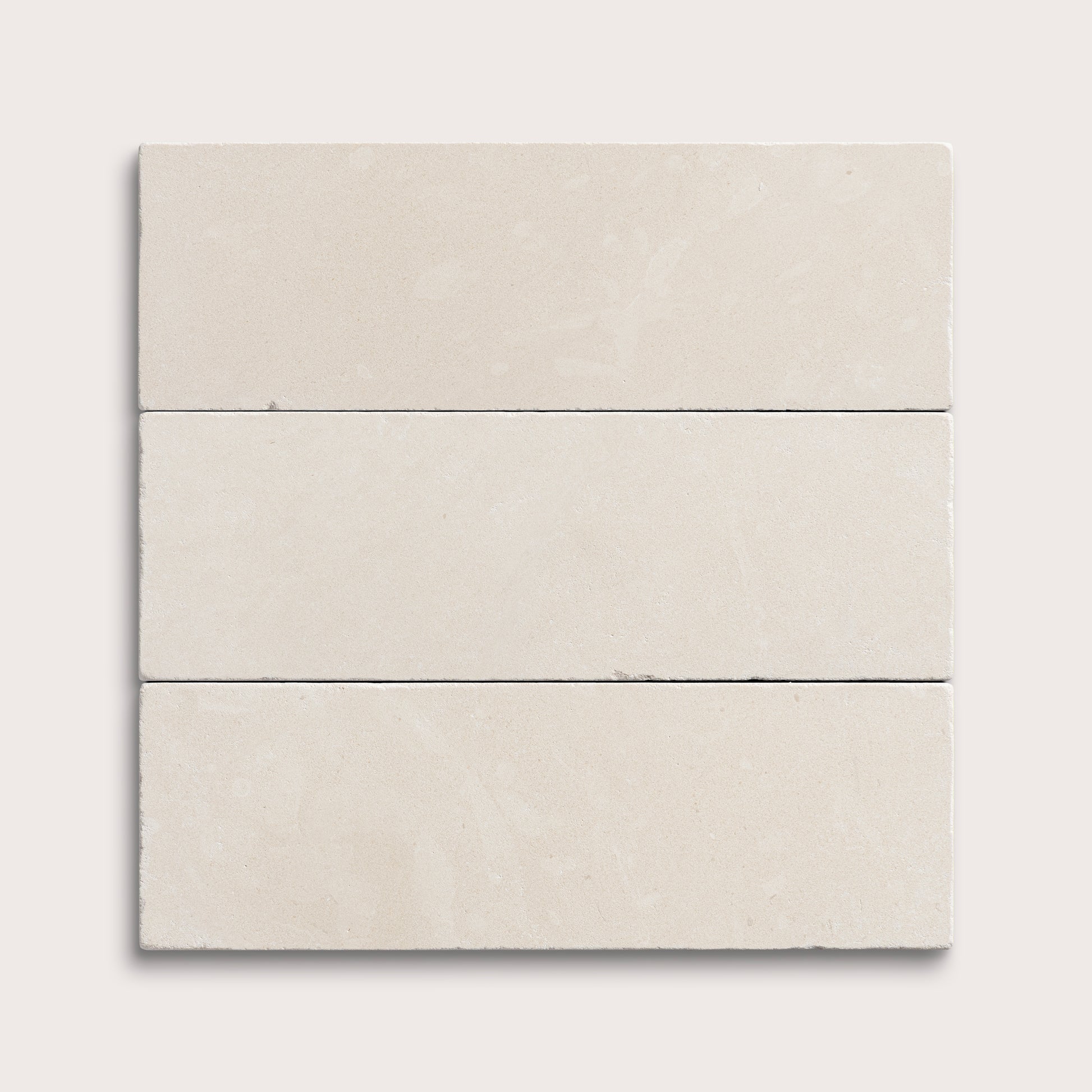 three rectangle tiles with a white limestone pattern on a white background