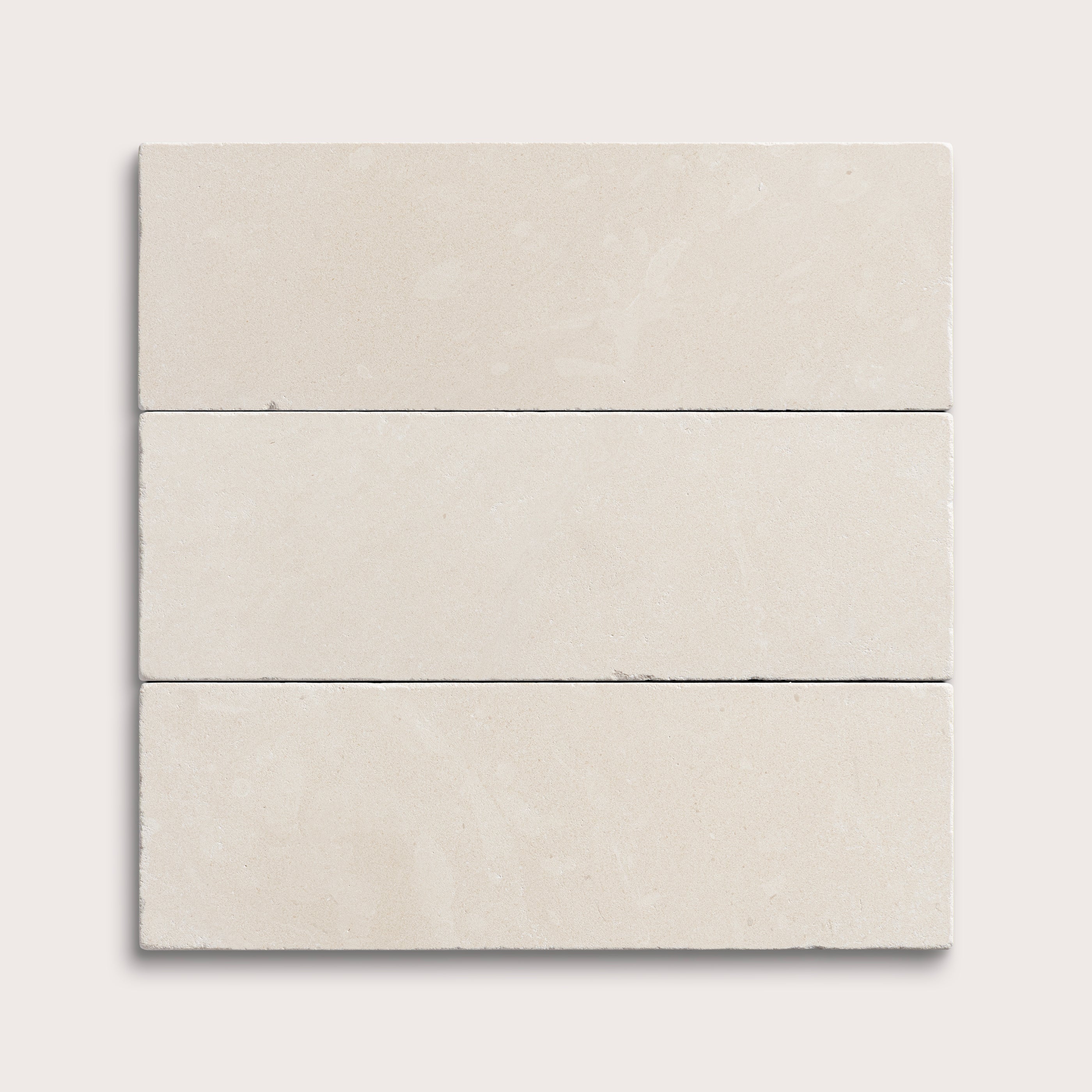 three rectangle tiles with a white limestone pattern on a white background